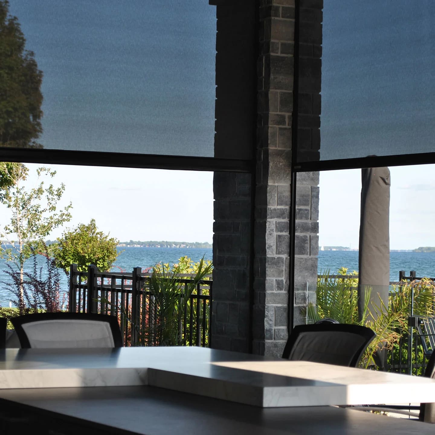 Smart-controlled motorized screens on a modern patio